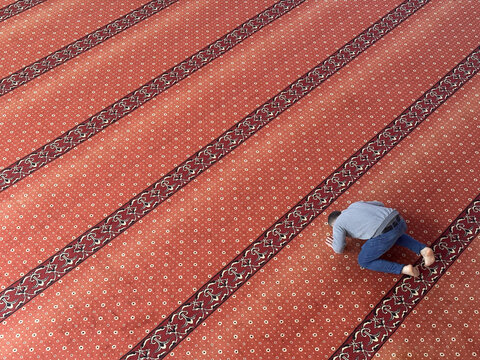 Muslim adult man praying in mosque