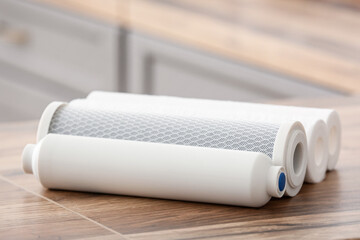 Water filters on wooden table in kitchen