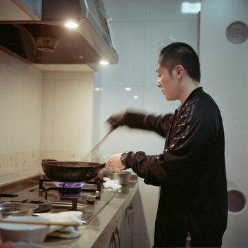A man is cooking in the kitchen