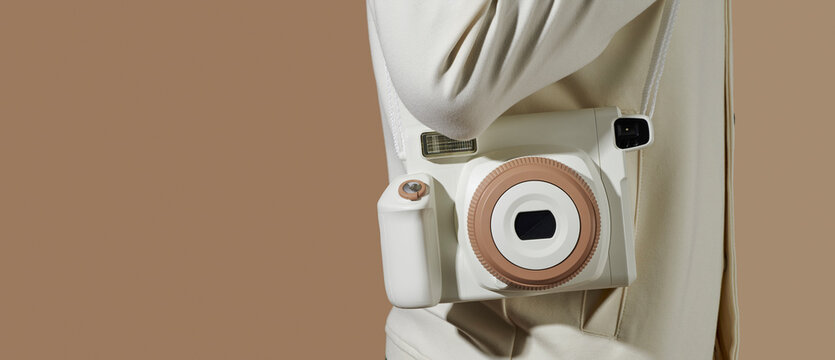 man carrying an instant camera in a panoramic format