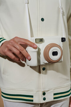 takes a picture with an instant camera