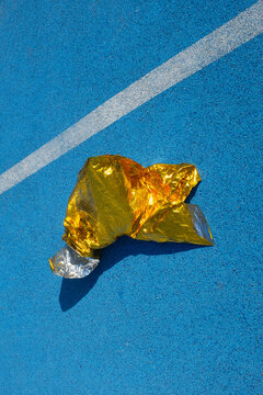 Golden metallic folio on a  blue sport running track