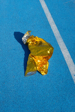 Golden metallic folio on a  blue sport running track