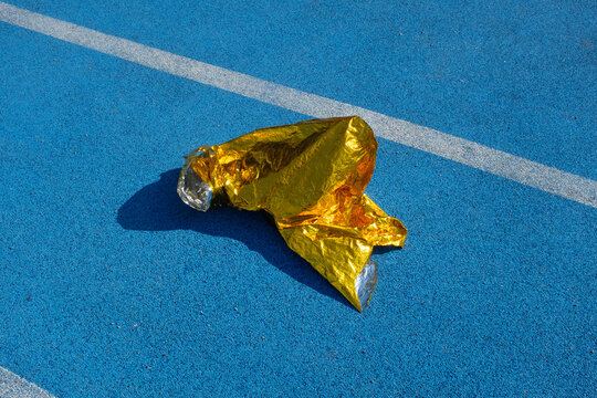 Golden metallic folio on a  blue sport running track