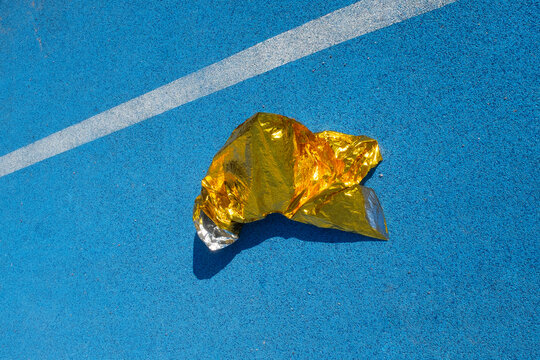 Golden metallic folio on a  blue sport running track