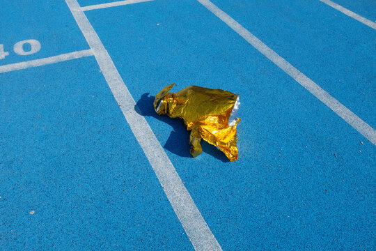 Golden metallic folio on a  blue sport running track