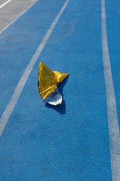 Golden metallic folio on a  blue sport running track