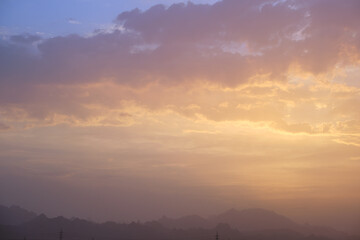 Fototapeta na wymiar Sunset landscape with dark mountain peaks in egyptian desert