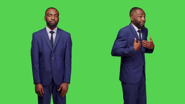 Office employee in business suit saying no in studio, being displeased and doing rejection gesture over greenscreen. Startup worker showing negative reaction and being confused, disagree.