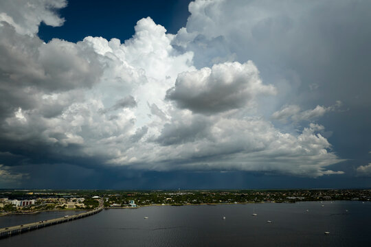 Stormy clouds forming from evaporating humidity of ocean water before thunderstorm over traffic bridge connecting Punta Gorda and Port Charlotte over Peace River. Bad weather conditions for driving