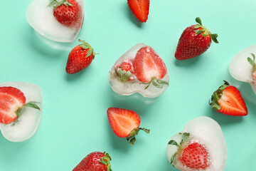 Fresh strawberry frozen in ice on blue background