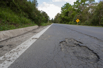 Highway br-153, in the city of Rio Azul, Paraná, with several holes in the lane, denoting poor...