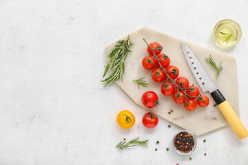 Board with fresh cherry tomatoes and rosemary on white background
