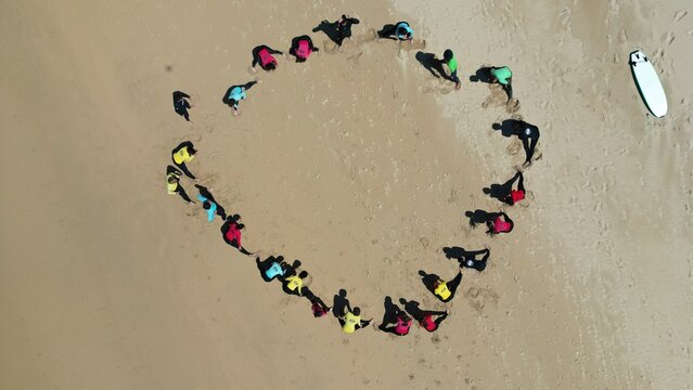 circle of people on the beach