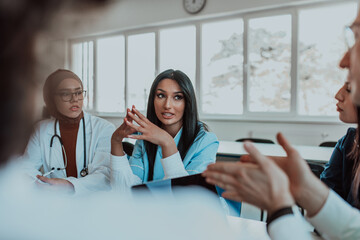 A group of multiethnic medical professionals including doctors, surgeons, and nurses are gathered...