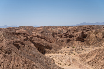 Borrego Springs, CA, USA - April 24, 2023: Ocotillo Wells viewpoint along Borrego Salton Sea Way or S22 shows sandy trails on rough rocky landscape under blue sky