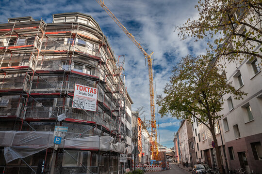 COLOGNE, GERMANY - NOVEMBER 9, 2022: typical residential street of the old town of Cologne, in the Eigelstein viertel district of Altstadt Koln, with construction site of a building under renovation.