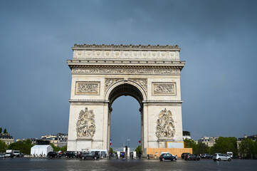 Paris, France: Arc de Triomphe in city centre. People visiting popular tourist attraction and historic landmarc in Paris. 