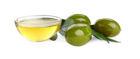 Cooking oil in glass bowl, olives and leaves on white background