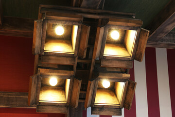 Stylish pendant lamps on ceiling in hotel room
