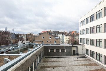 Buildings with windows under grey sky in city