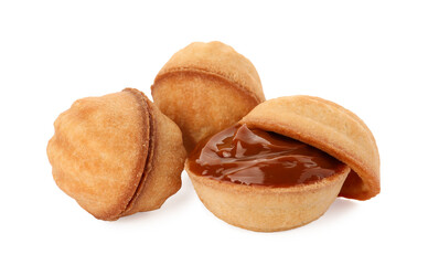 Delicious nut shaped cookies with boiled condensed milk on white background