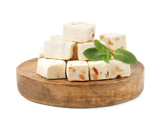 Pieces of delicious nougat and mint isolated on white