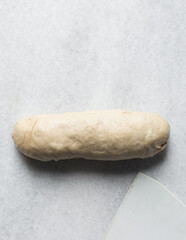 Bread dough resting on a table, Kanelbullar dough or Swedish cinnamon twist dough on a marble surface, process of making Swedish cinnamon buns