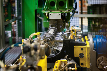 Fototapeta premium Illuminated car engine on test stand in production plant shop