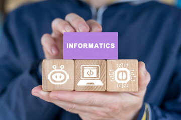 Schoolboy or student holding colorful blocks and sees word: INFORMATICS. Informatics School...