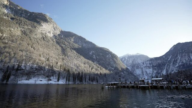 Tourists getting off tour boat at dock in Koenigssee in scenic lake
