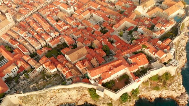 An aerial view of a Dubrovnik Old Town. The walls and historic old town can be seen in this drone clip. Birds eye view of the city.