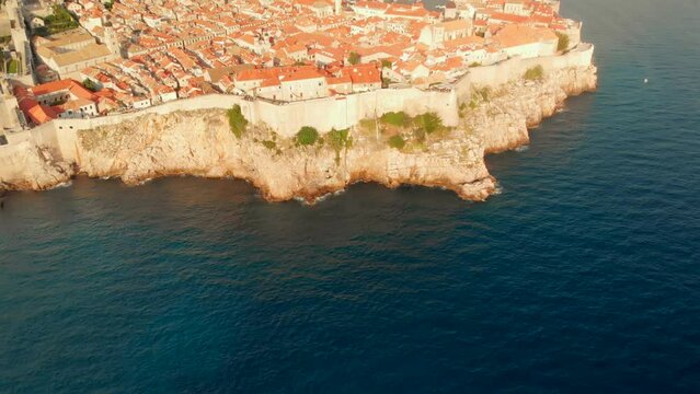 An aerial view of a Dubrovnik Old Town. The walls and historic old town can be seen in this drone clip.