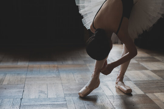 teenage ballerina trying point shoe in a studio 