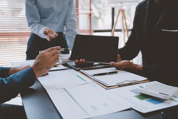 business group meeting Team work with project planning documents Calculate the budget, consult, analyze, summarize the performance on the desk in the office.