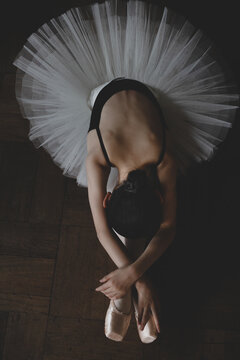 Teenage ballerina stretching on the floor