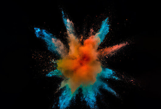Explosion of colorful powder isolated on black background