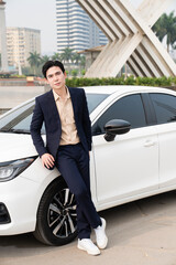 Fototapeta na wymiar Young Asian business man with car