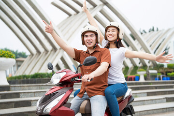 Young Asian couple on the motorbike