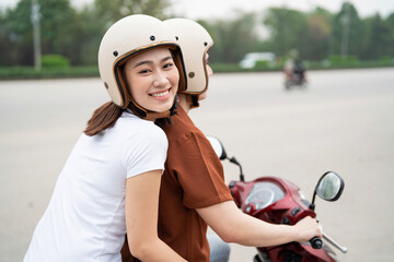 Fototapeta na wymiar Young Asian couple on the motorbike