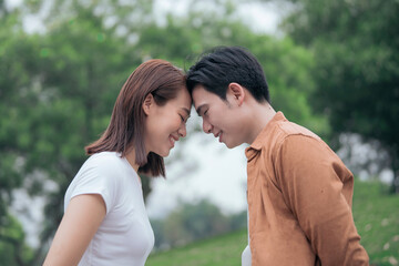 Photo of young Asian couple outside