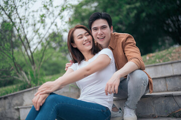 Photo of young Asian couple outside