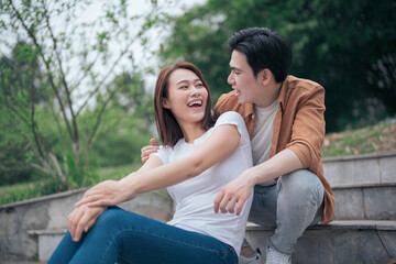 Photo of young Asian couple outside