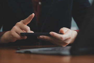 Asian Businesswoman Using laptop computer and working at office with calculator document on desk, doing planning analyzing the financial report, business plan investment, finance analysis concept.