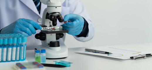 Medical development laboratory, scientists look under the microscope. Analysis of petri dishes, gold catheters, specialists working in medicine Biotechnology research in advanced pharmaceutical labs.