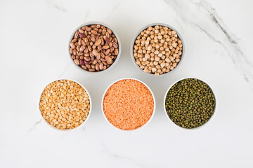 Legumes in glass jars top view. Vegetable protein, vegetarianism, healthy eating