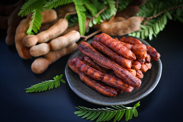 Tamarind sweet for food fruit ripe tamarinds on dark plate background, Tamarind peel tropical fruits summer