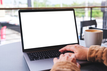 Mockup image of a woman using and working on laptop computer with blank white desktop screen - obrazy, fototapety, plakaty