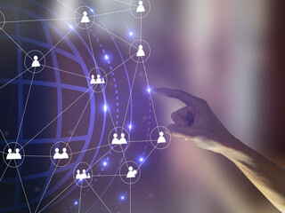 A Hand person points to a network of people on a screen. hologram pattern and blurred background