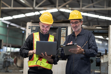 Group of male engineer worker discuss and working with laptop computer in factory. Team of male technician inspecting quality in plant during manufacturing process